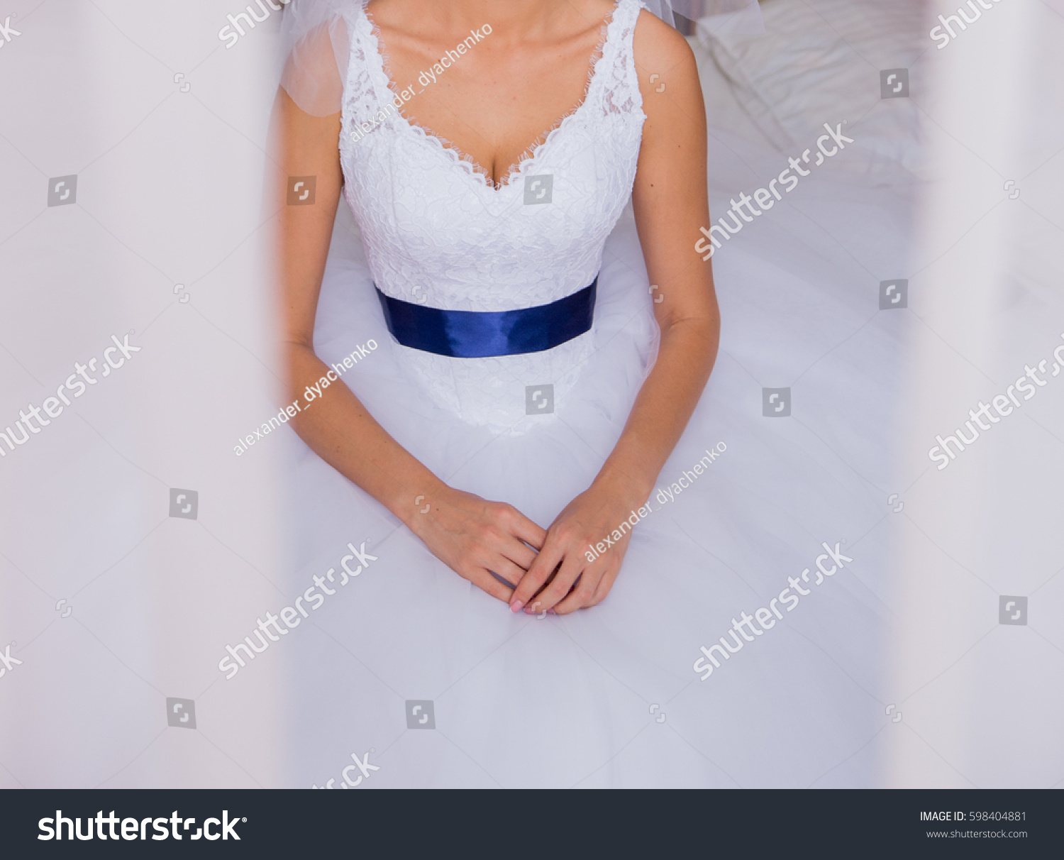 white dress with blue ribbon