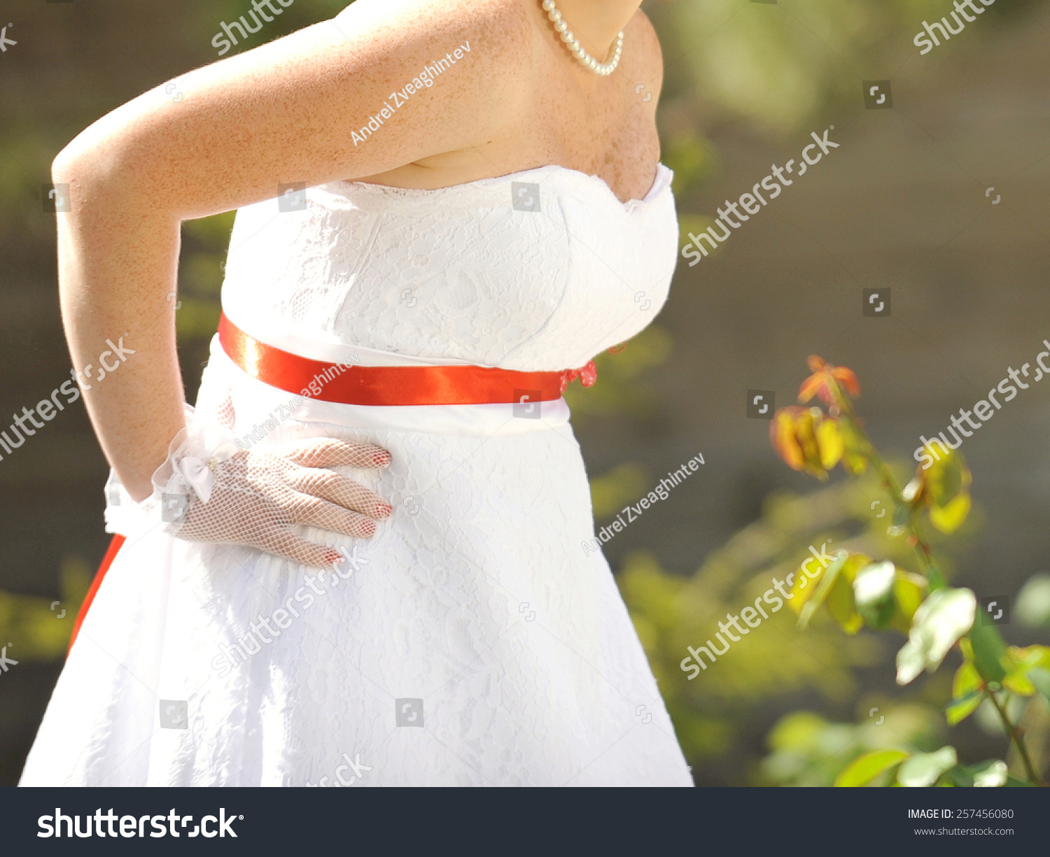 wedding dress with red ribbon on waist