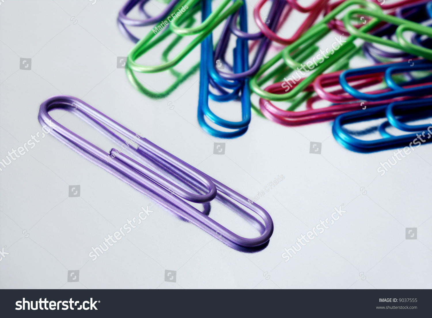 Bright Metallic Colored Paper Clips On A Silver Reflective Background ...