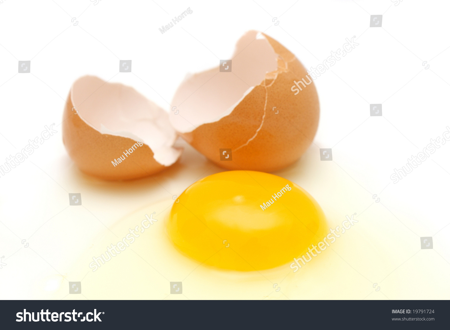 Broken Egg With Yolk, Albumin And Eggshell Over White Background. Stock ...