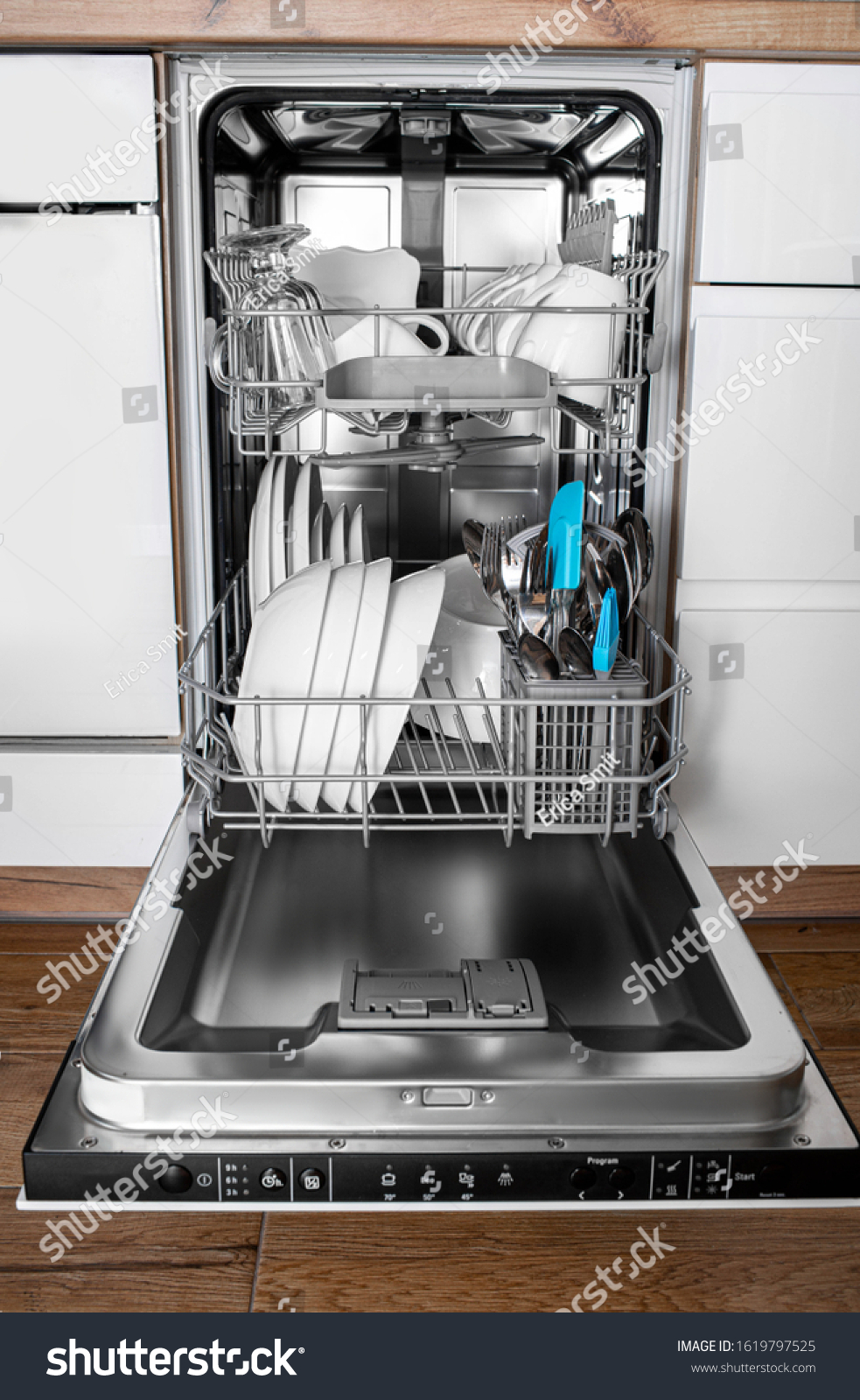 stock photo built in dishwasher in a modern kitchen with clean dishes after washing front view 1619797525