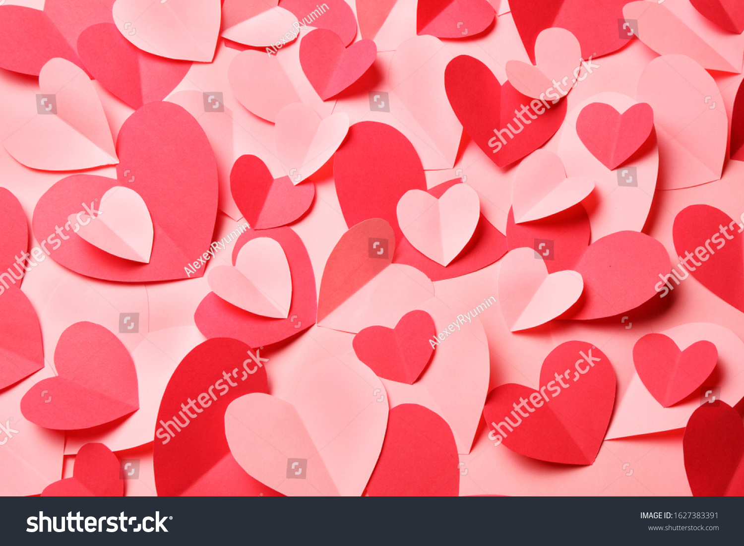 Bunch of cut out of pink and red paper hearts on pink background. Cute Valentines day, Womans day, love, romantic or wedding card, banner, invitation, sale, offer, ad background for banner, congratulation, card, offer, flyer, advertising, invitation.
