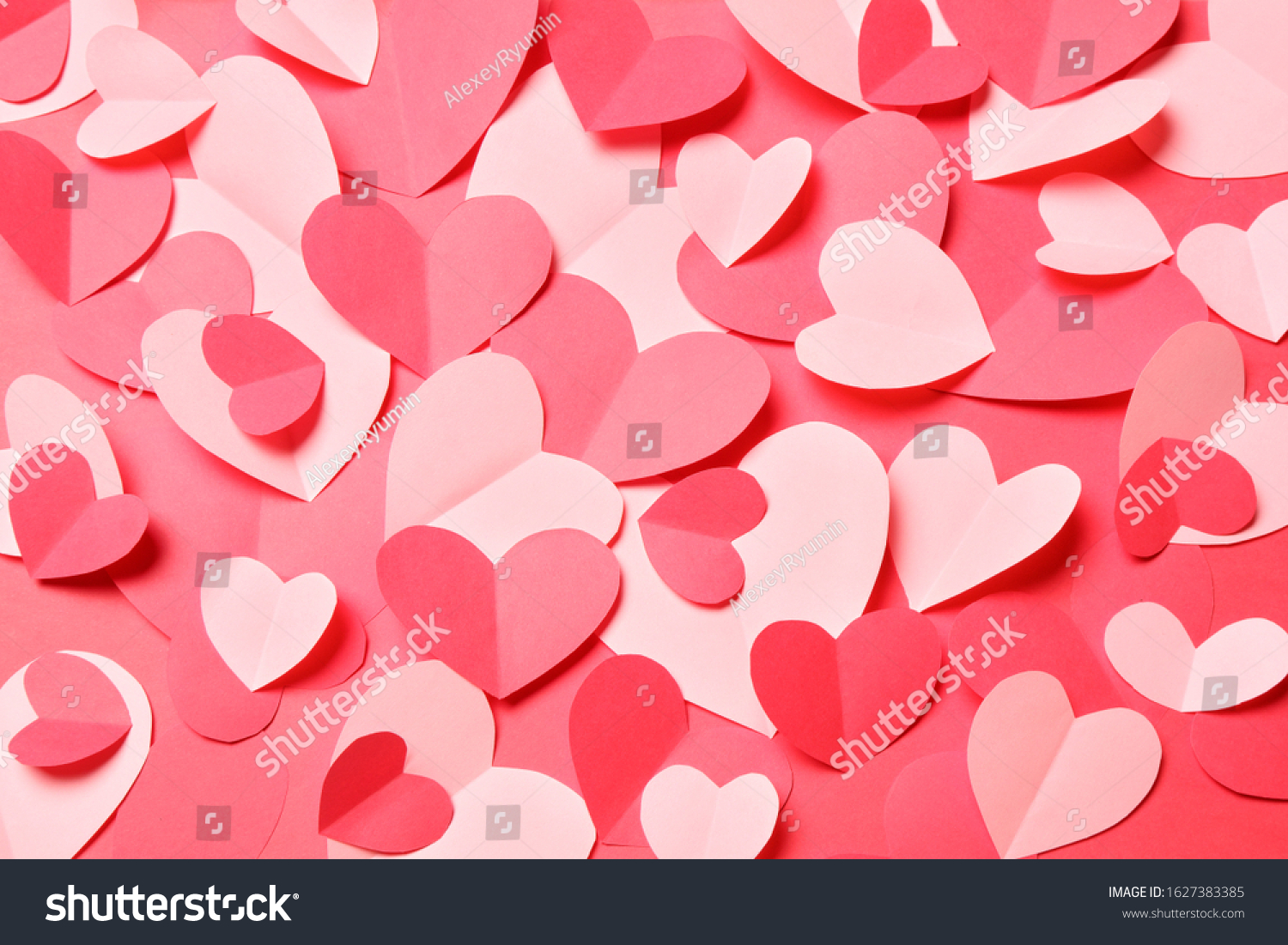 Bunch of cut out of pink and red paper hearts on red background. Cute Valentines day, Womans day, love, romantic or wedding card, banner, invitation, sale, offer, ad background  for banner, congratulation, card, offer, flyer, advertising, invitation.