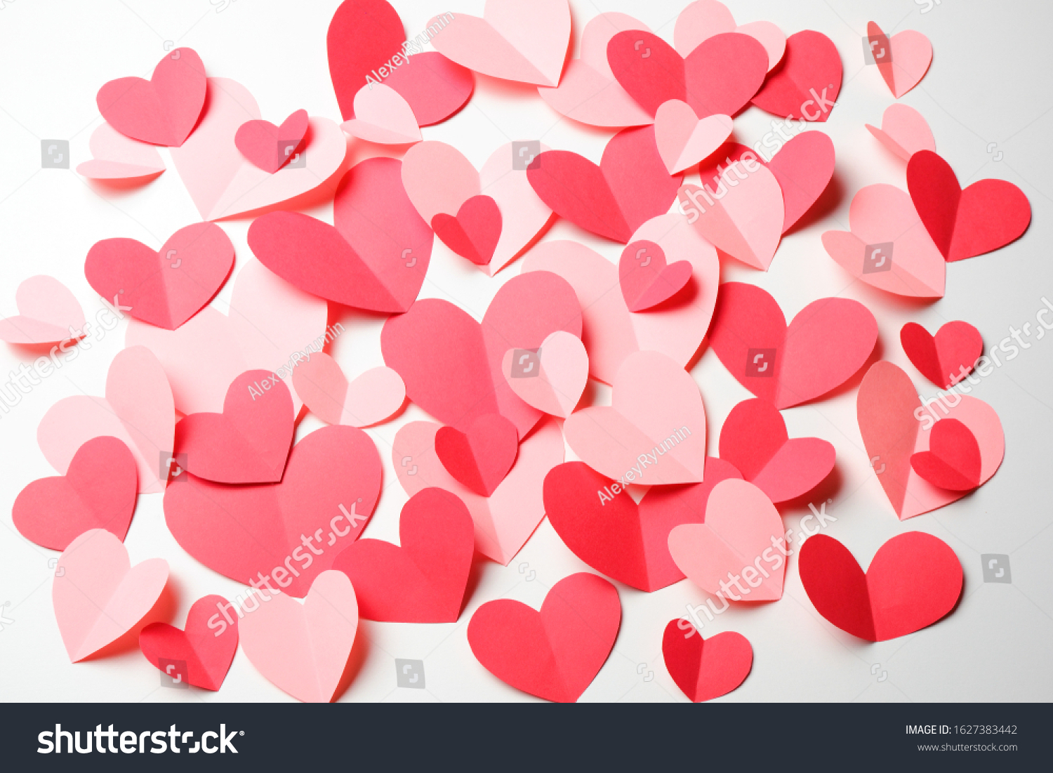 Bunch of cut out of pink and red paper hearts on white background. Good Valentines day, Womans day, love, romantic or wedding card, banner, invitation background for banner, congratulation, card, offer, flyer, advertising, invitation.