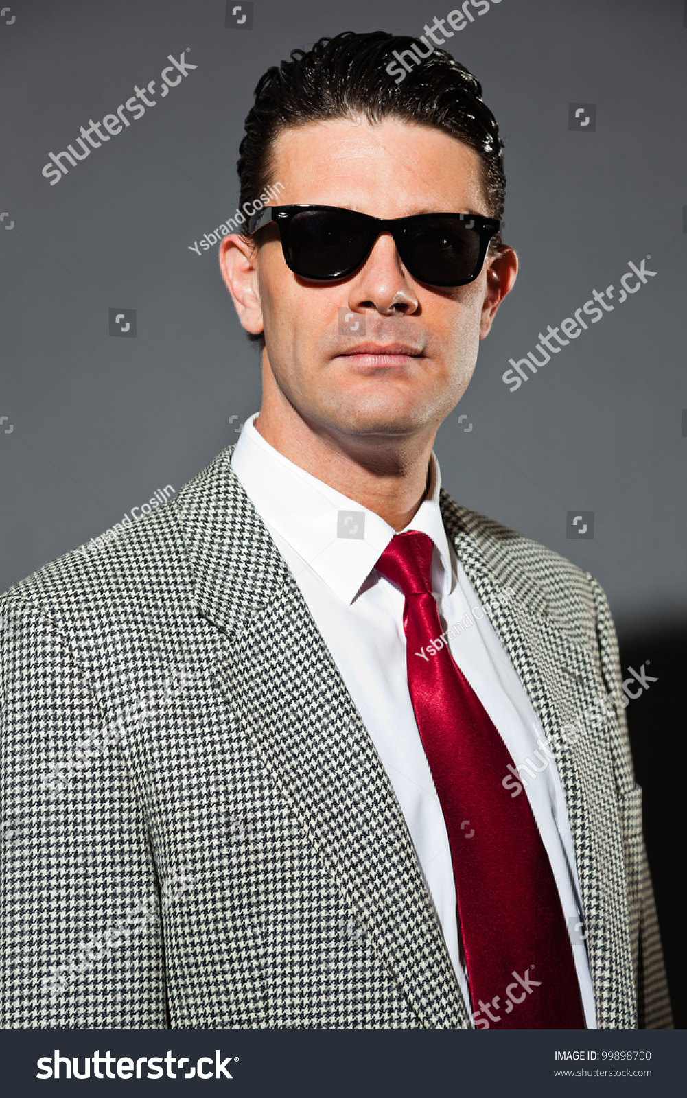 light grey suit with red tie