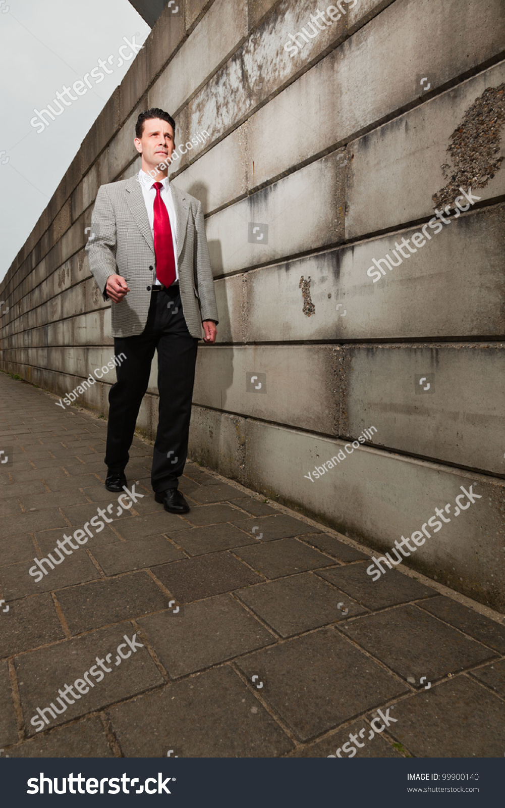 light grey suit with red tie