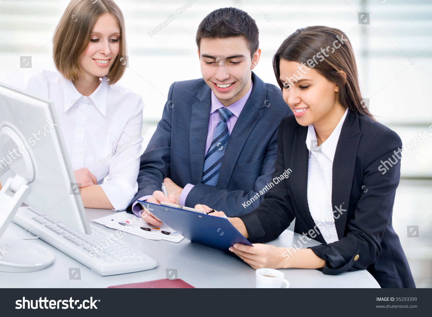 http://image.shutterstock.com/z/stock-photo-business-people-analyzing-and-discussing-during-a-working-meeting-in-a-modern-office-95293399.jpg