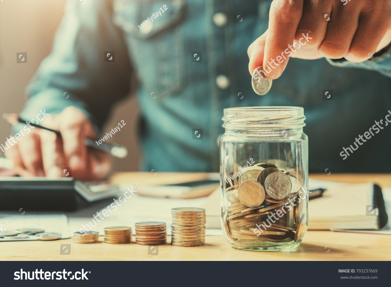 businessman holding coins putting in glass. concept saving money for finance accounting