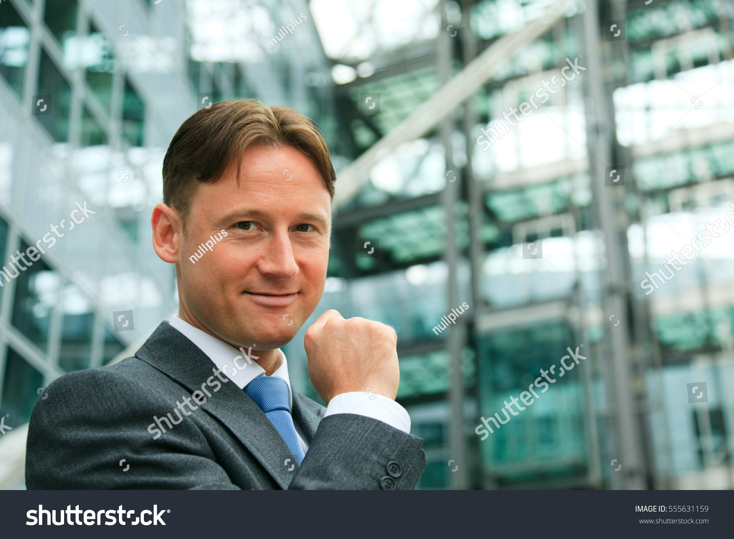 businessman-front-office-building-stock-photo-555631159-shutterstock