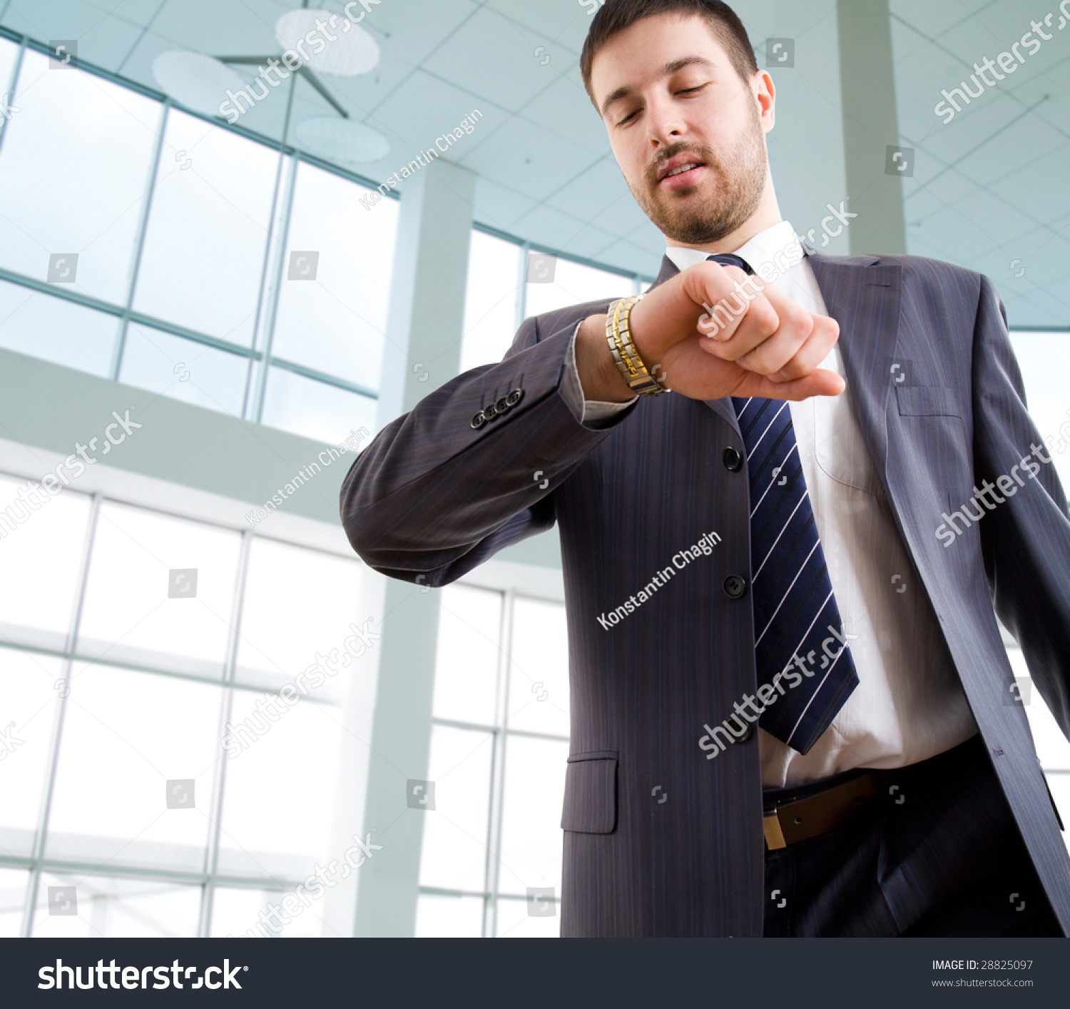 Businessman Looking At Wrist Watch In Office Stock Photo 28825097 ...