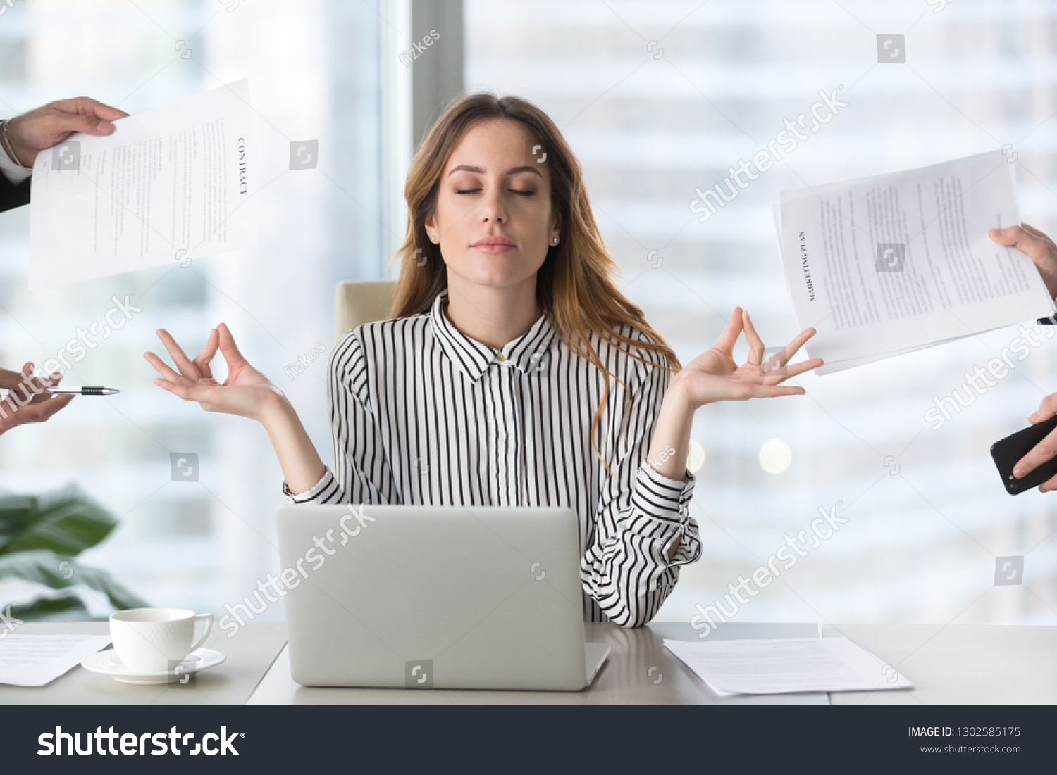Calm female executive meditating taking break at work for mental balance, mindful businesswoman feeling relief and no stress doing yoga at work ignoring avoiding stressful job and paperwork in office