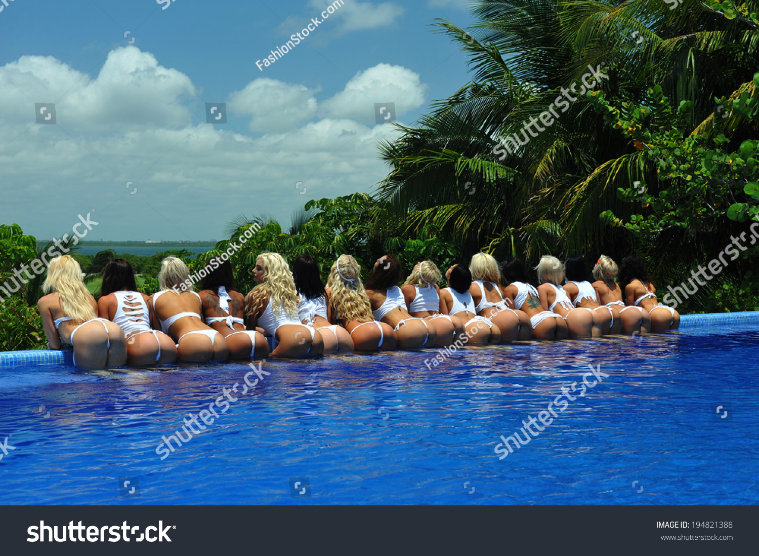 stock photo cancun mexico may models poses by the edge of pool for white t shirt project during ibms 194821388