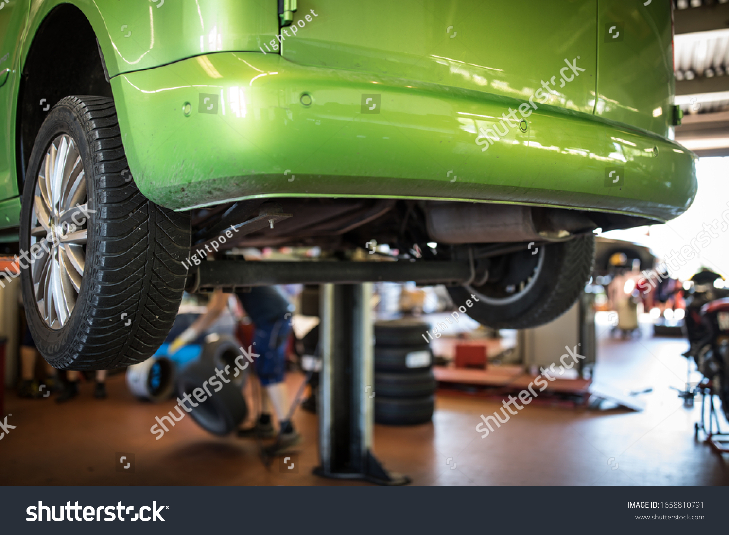 Stock Photo Car In A Garage For Maintenance Oil Tyre Change Shallow Dof Color Toned Image 1658810791 