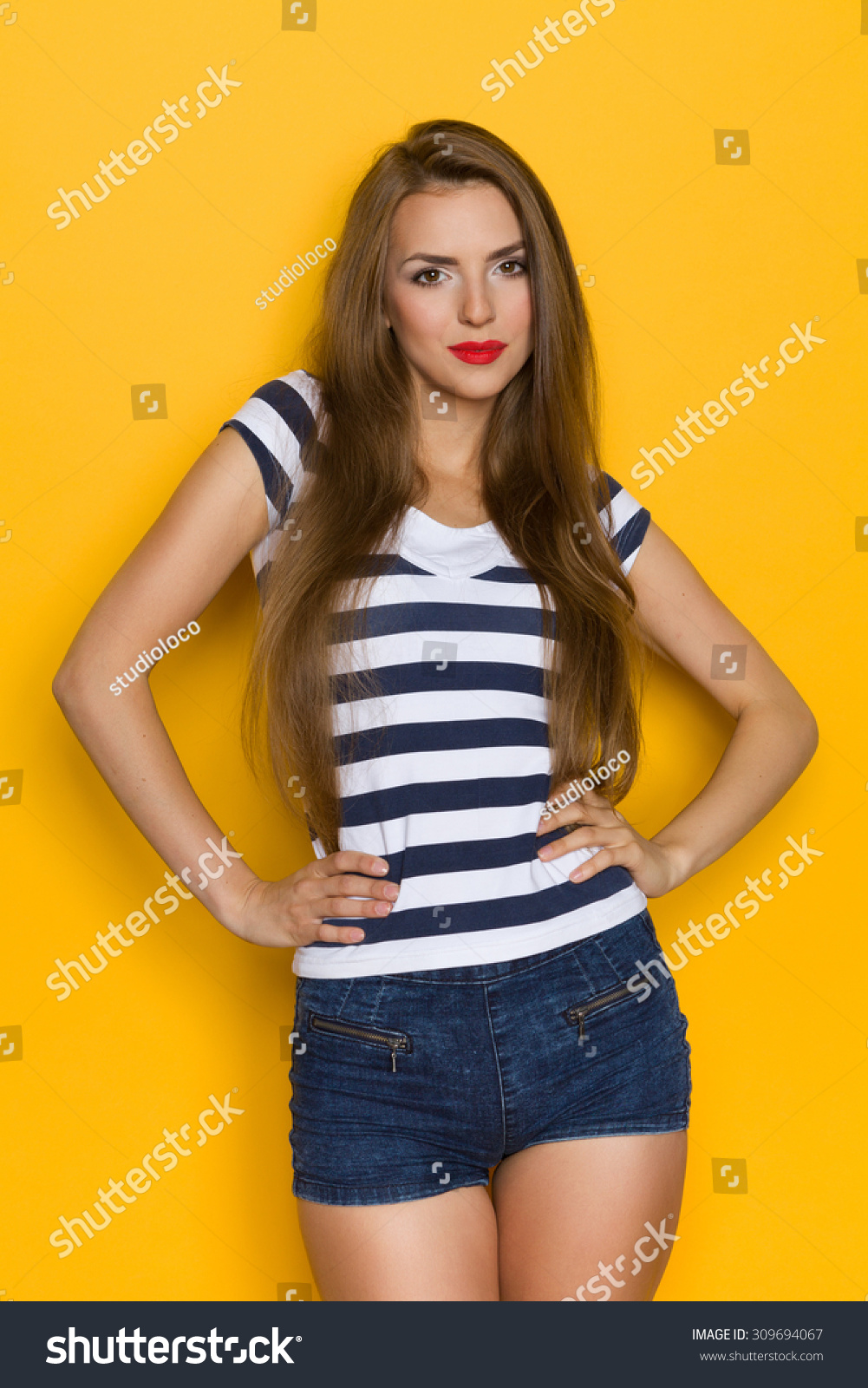 Cheerful Girl In Striped Shirt. Beautiful Young Woman Posing With Hands ...