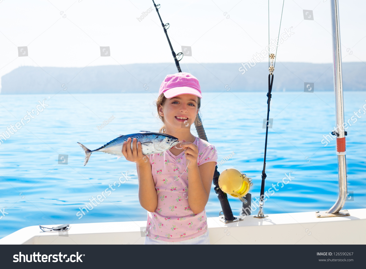 stock-photo-child-little-girl-fishing-in-boat-holding-little-tunny-tuna-fish-catch-with-rod-and-trolling-reels-126590267.jpg