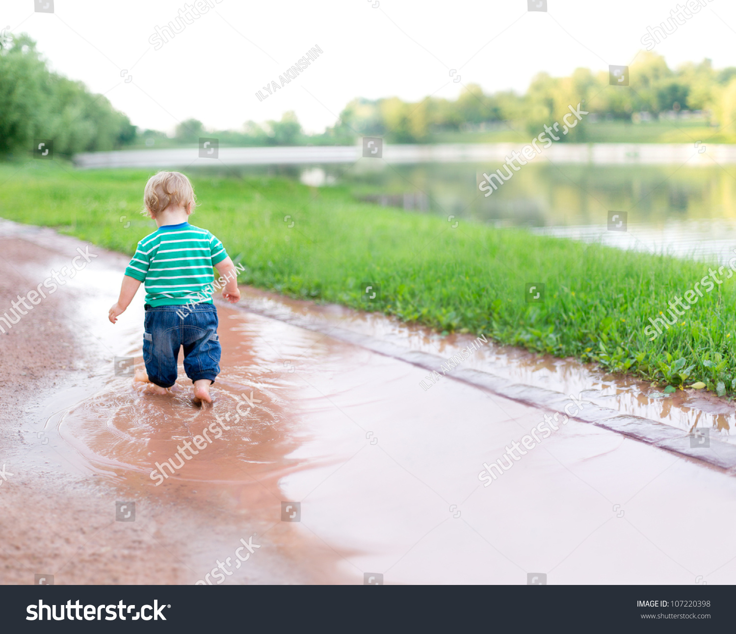 Child Walks On The Puddles After The Rain Stock Photo 107220398 ...