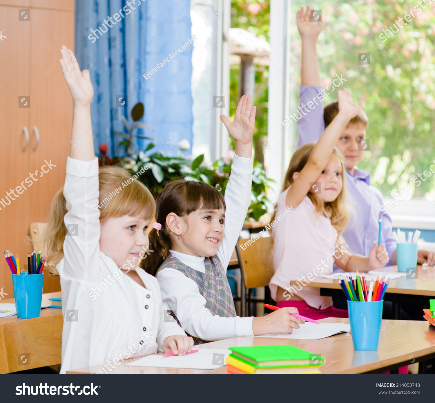 Children Raising Hands Knowing The Answer To The Question Stock Photo ...