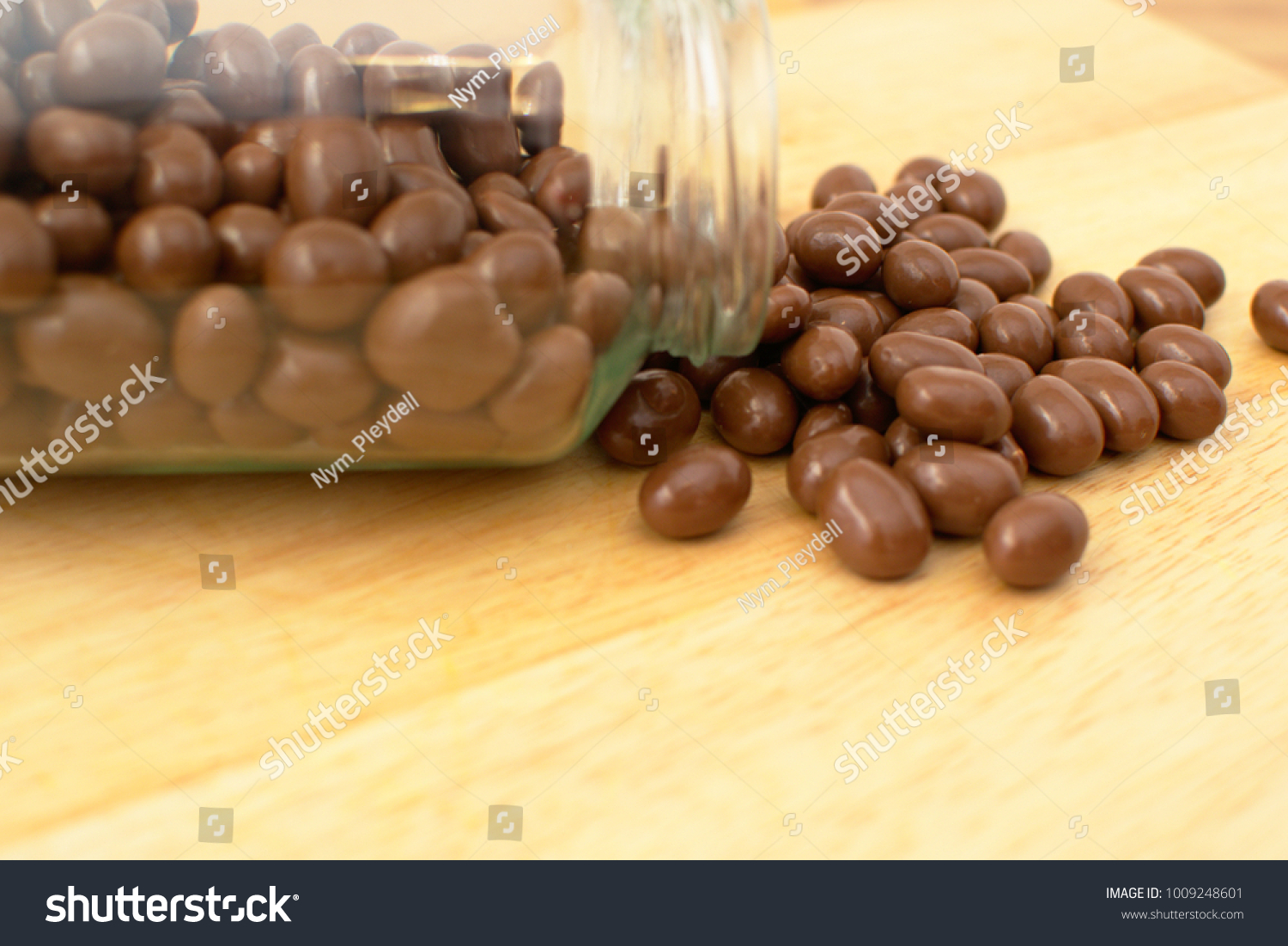 Download Chocolate Peanuts Coated Clear Glass Jar Stock Photo Edit Now 1009248601 Yellowimages Mockups