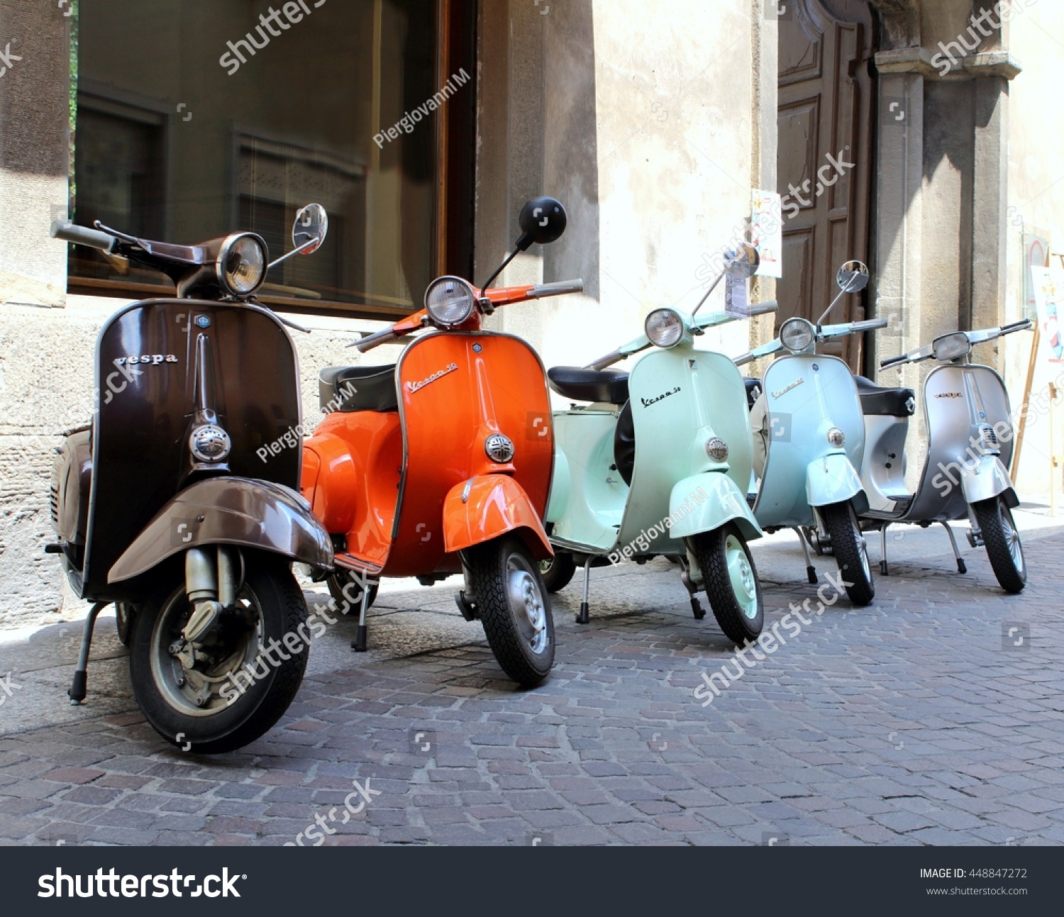 Classic Italian Scooters Parked In Ancient Street Old Town At Treviglio Vintage Festival Piaggio Vespa Classic Italian Scooters Parked In Ancient Street Old Town At Treviglio Vintage Festival Piaggio Vespa