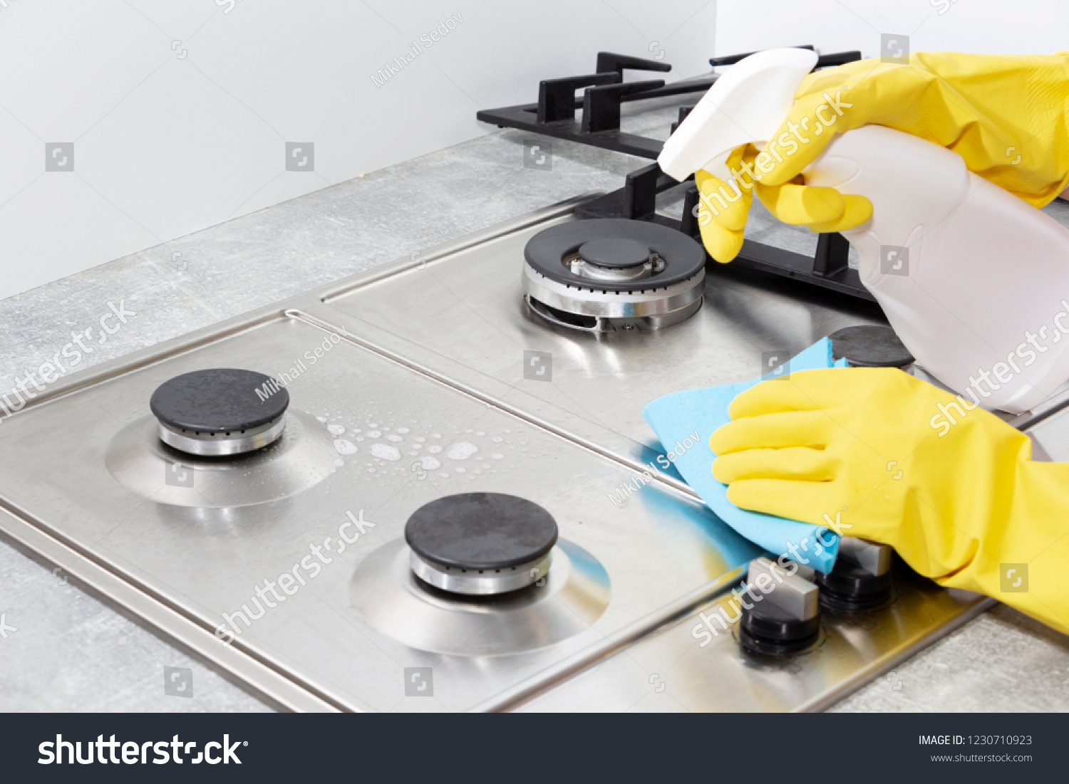 Stock Photo Cleaning A Gas Stove With Kitchen Utensils Household Concepts Or Hygiene And Cleaning 1230710923 
