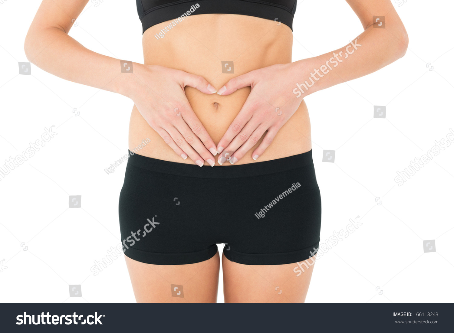 CloseUp Mid Section Of A Fit Woman In Black Shorts Over White