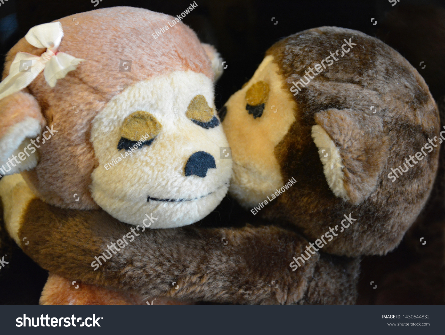 hugging stuffed monkeys