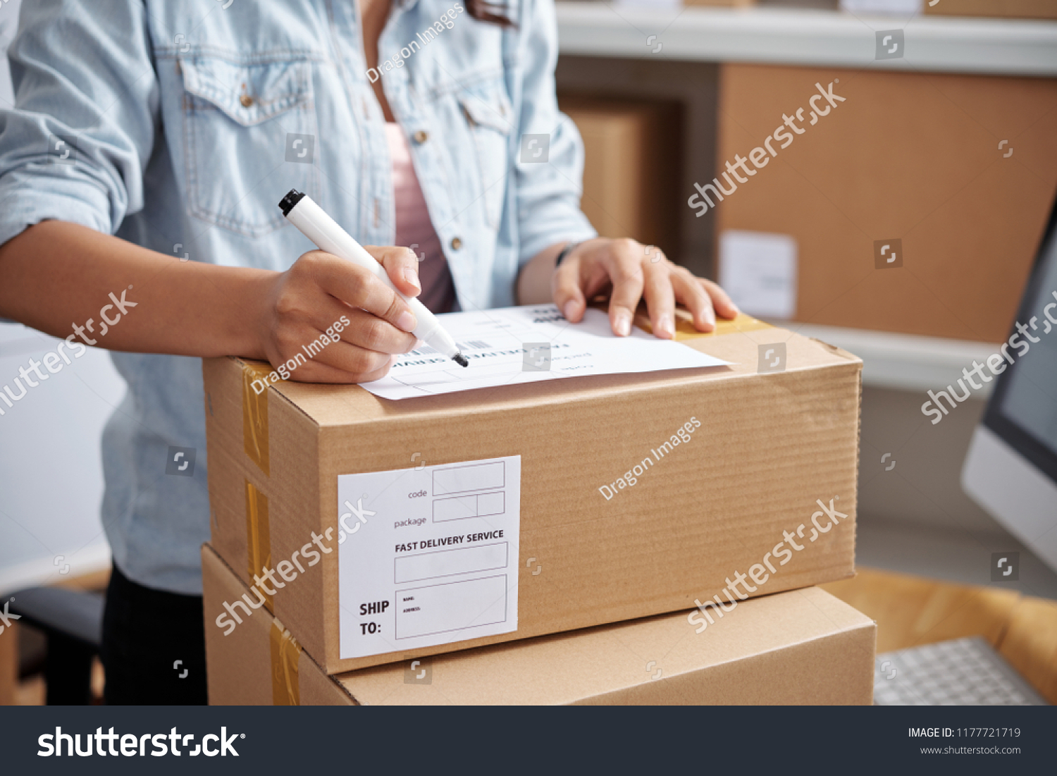 Closeup Woman Writing Address On Parcel Stock Photo (Edit Now