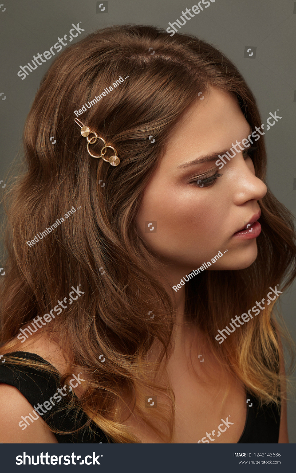 Close up portrait of a young brunette lady with natural make,up and wavy hairstyle