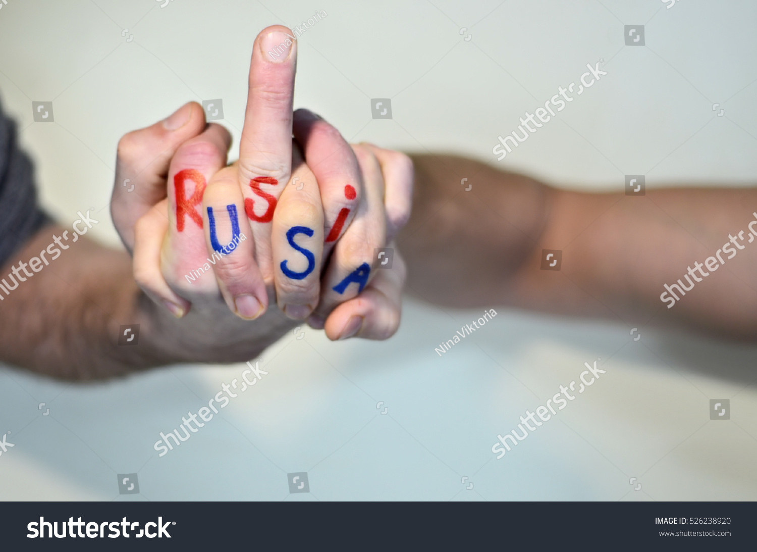 stock-photo-close-up-two-hands-locked-in-fight-on-the-one-of-the-hand-written-russia-on-another-usa-526238920.jpg