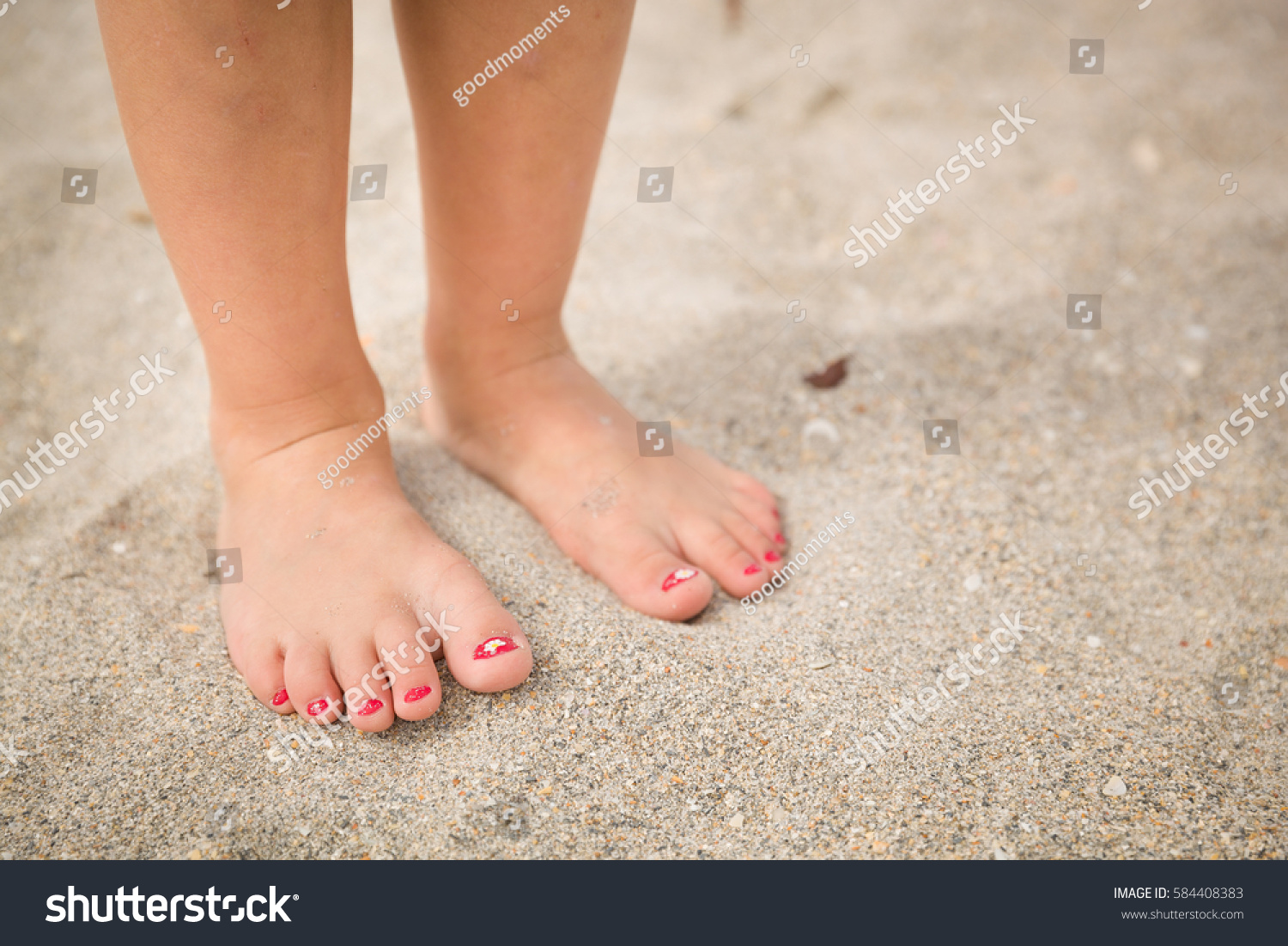 Stock Photo Closeup Of A Little Girl S Legs And Feet Walking On The Sand Of The Beach With The Sea Water In The 584408383 