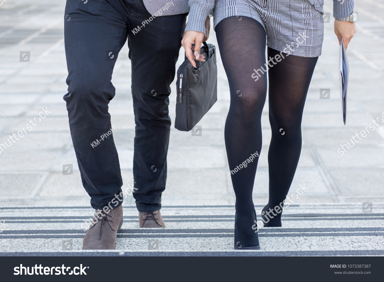 closeup-business-people-legs-walking-stairs-stock-photo-1073387387