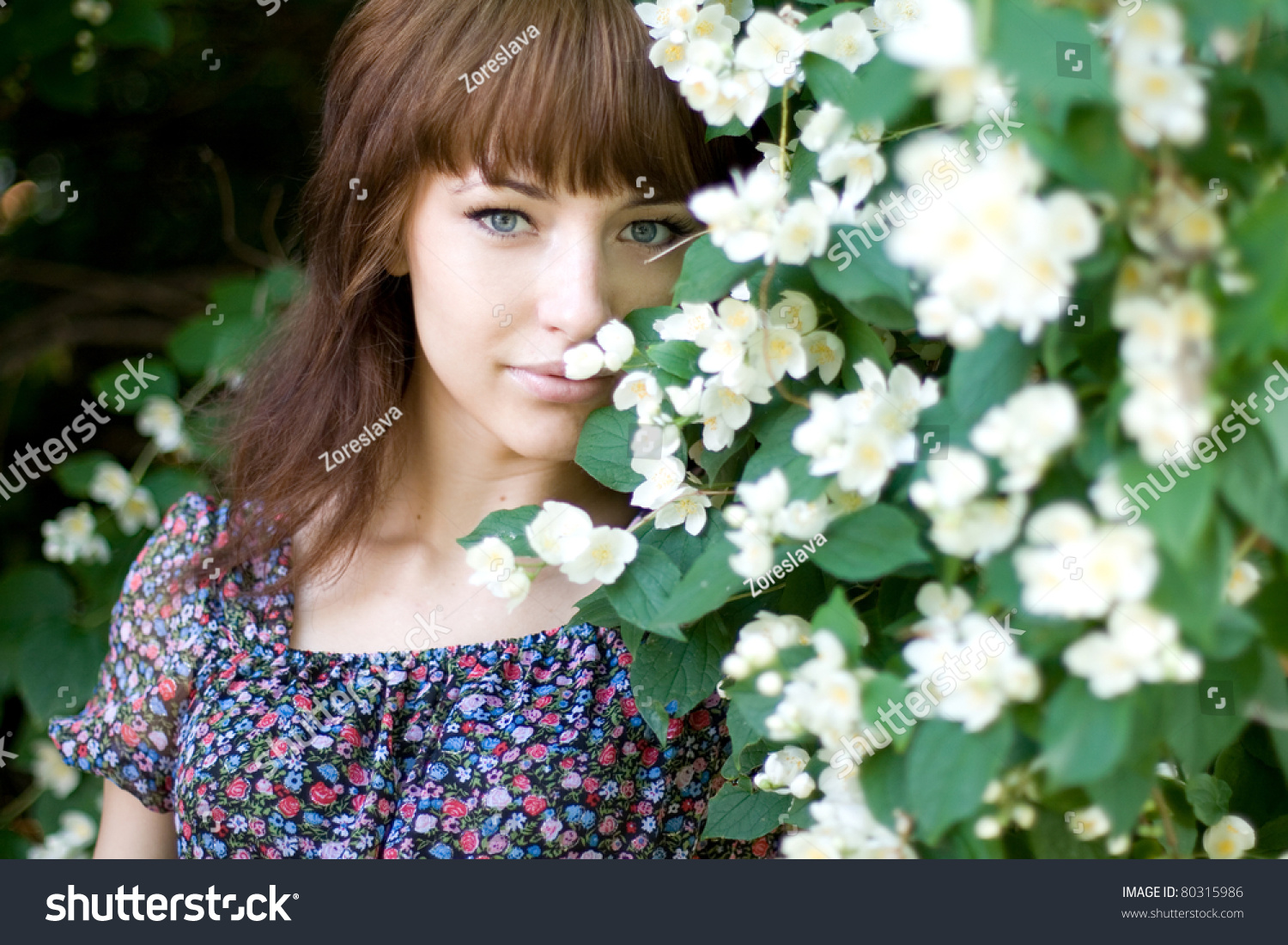 Closeup Portrait Of A Beautiful Girl Standing Among Flowers Stock Photo ...