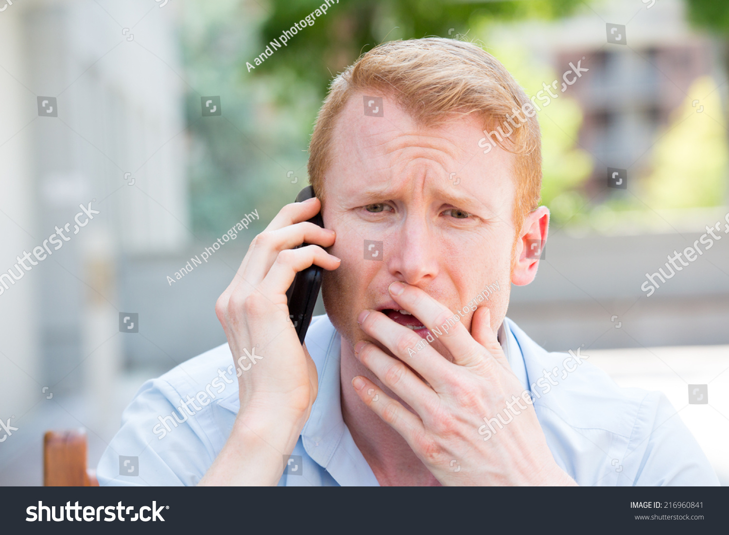 Closeup Portrait, Worried Young Man In Blue Shirt Talking On Phone To ...