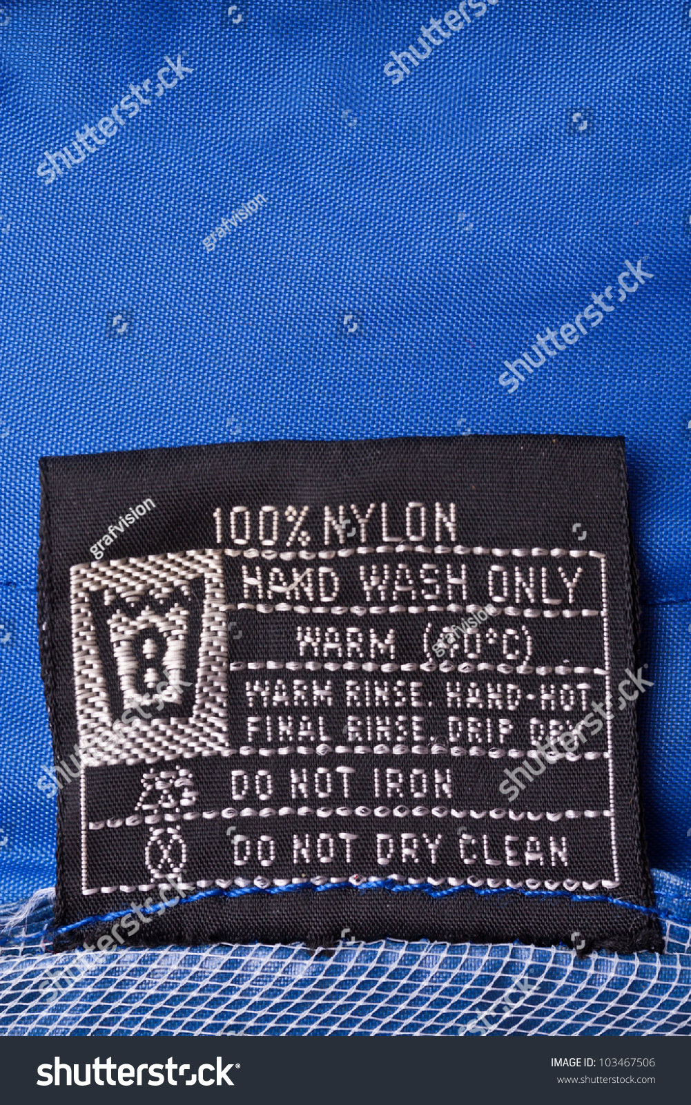 Clothing Label Washing Instruction Tag On Blue Raincoat Stock Photo ...