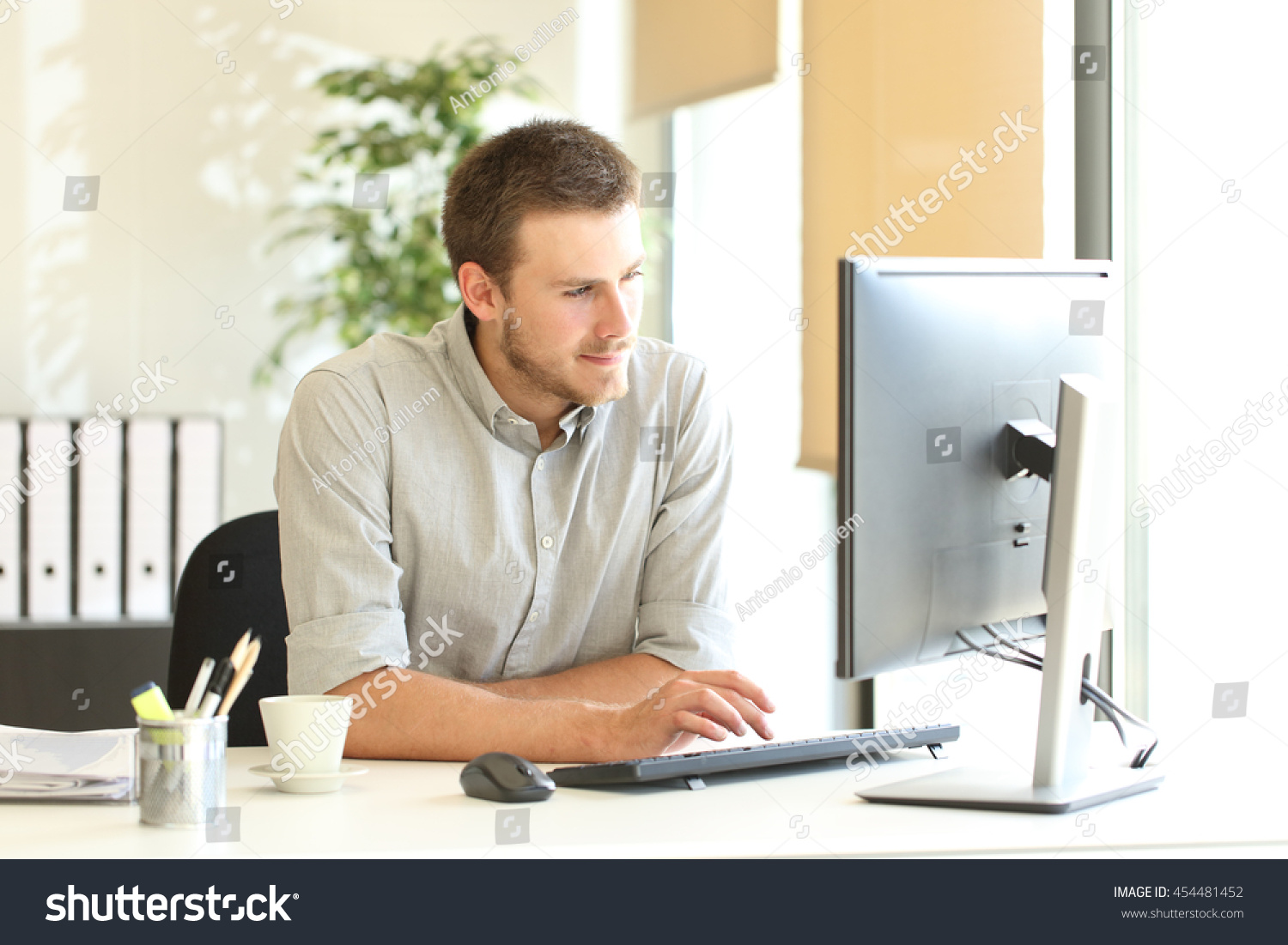 Confident Businessman Working On Line With A Computer At Office Near A ...