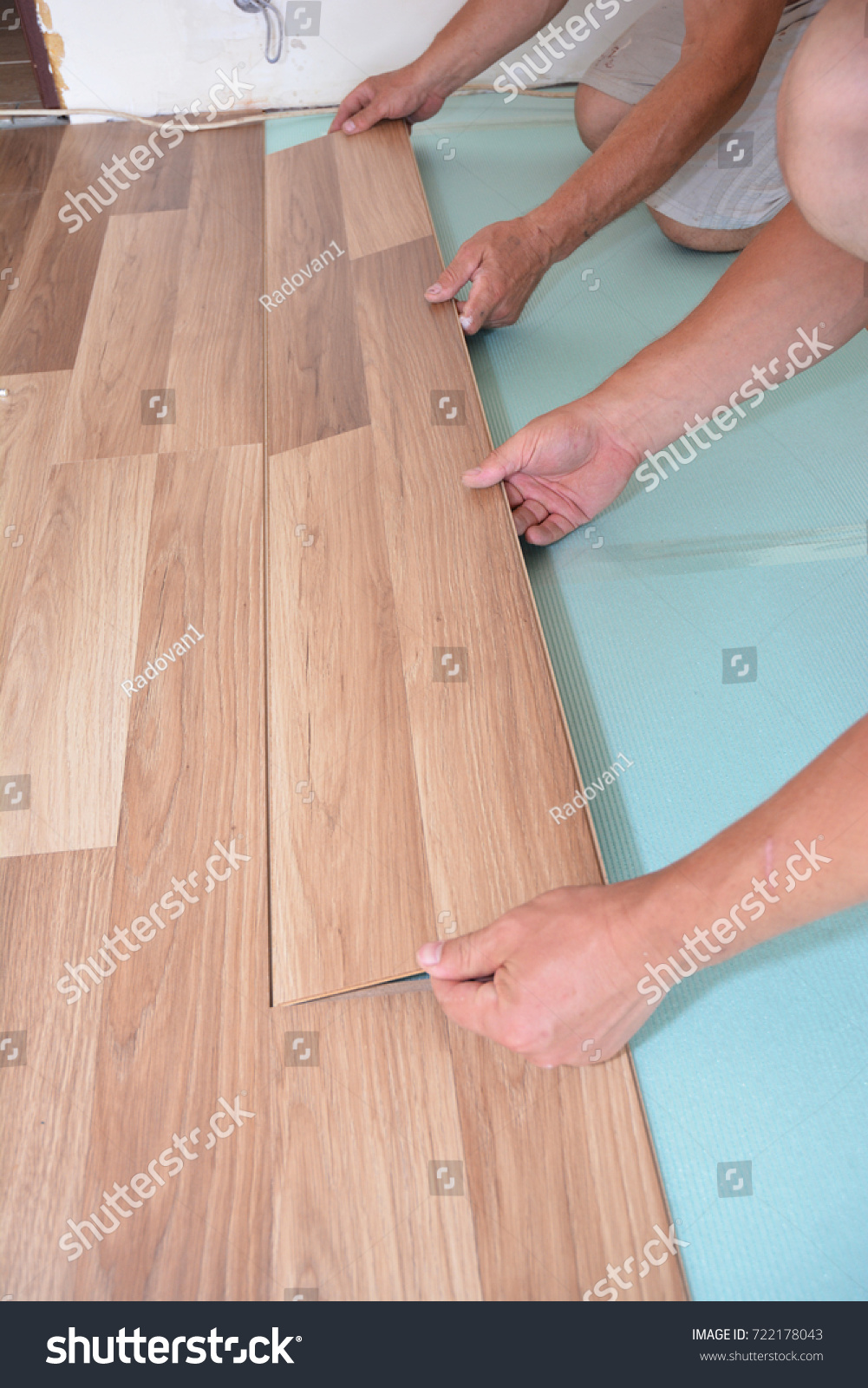 Contractors Installing Wooden Laminate Flooring Insulation Stock Contractors Installing Wooden Laminate Flooring With Insulation And Soundproofing Sheets Man Laying