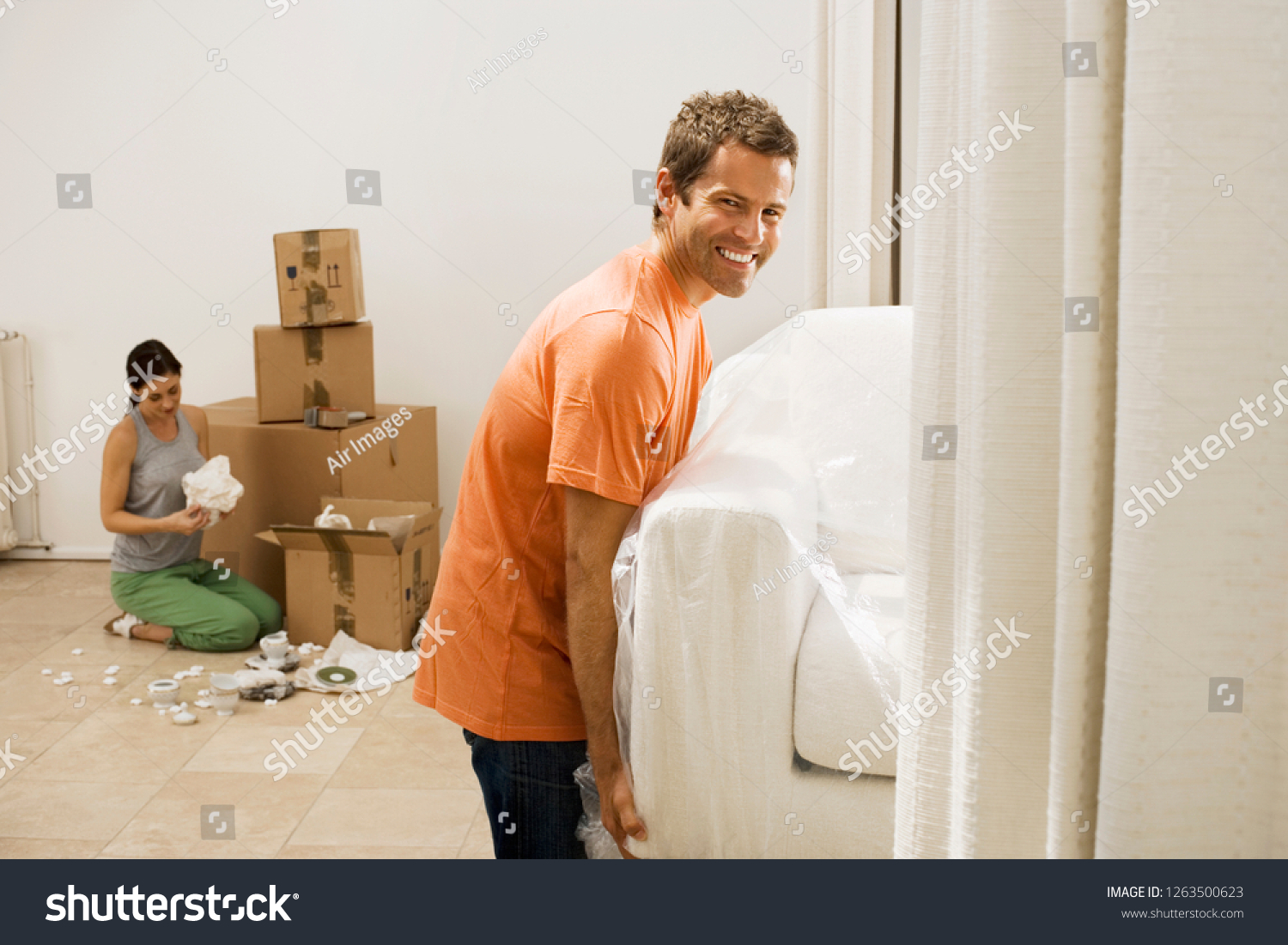 Couple Moving New Home Carrying Sofa Stock Photo Edit Now