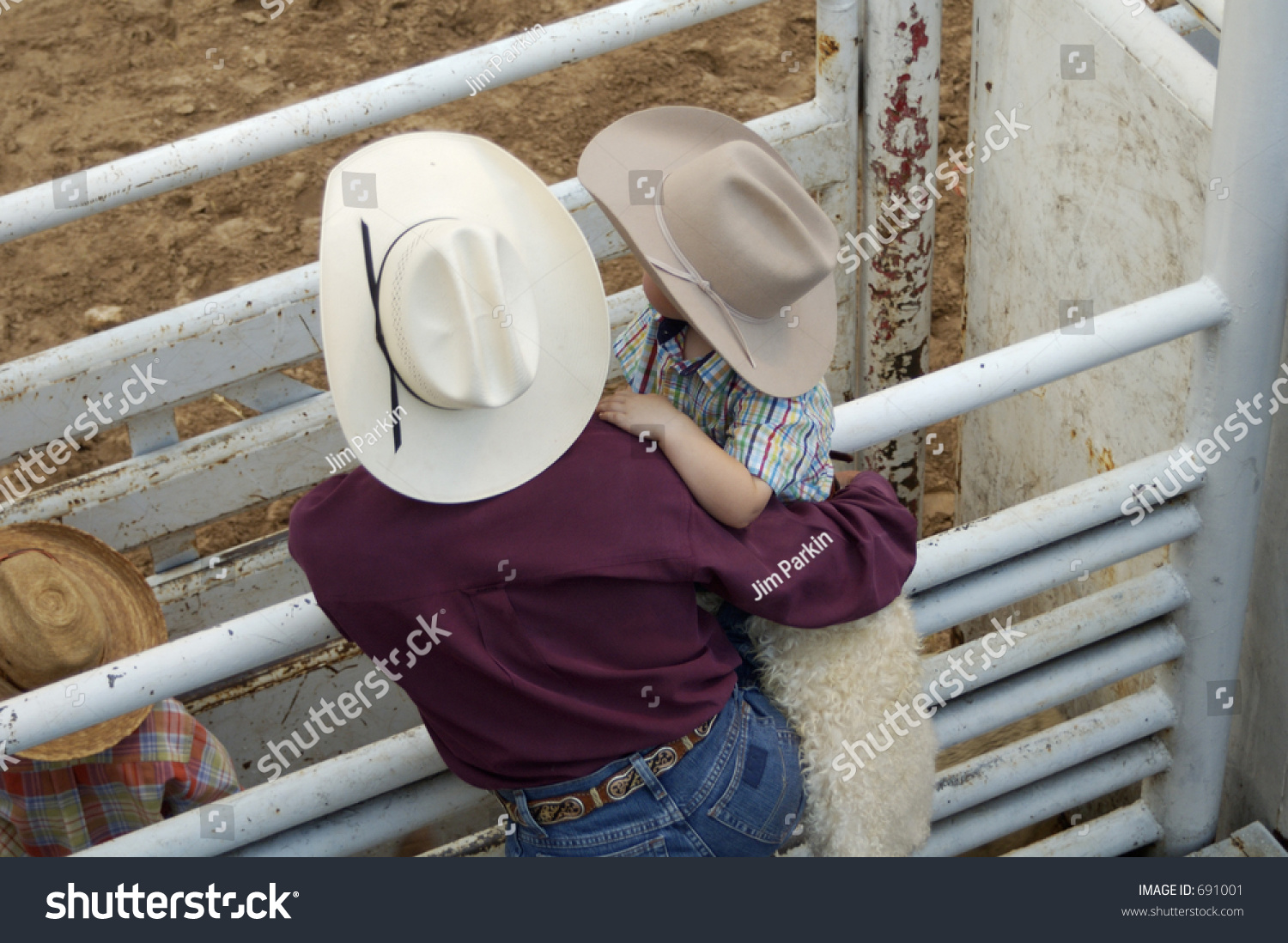 Cowboy Father And Son Watching Rodeo Action. Stock Photo 691001 ...