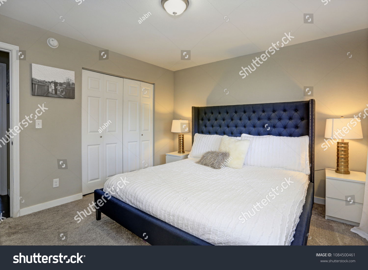 Cozy Bedroom Features Black Bed Tufted Stock Image