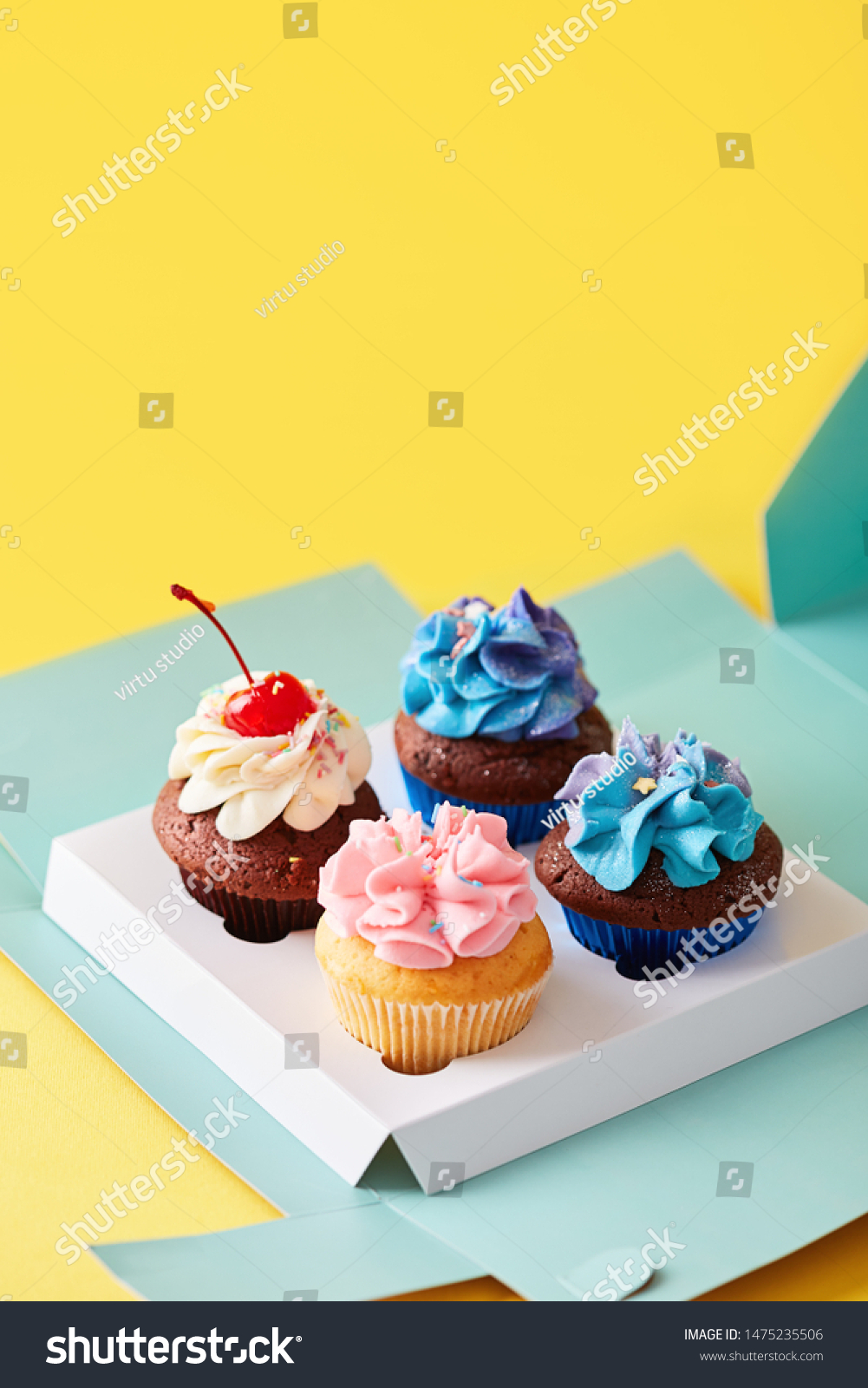 Download Cupcakes Variety Box On Yellow Background Stock Photo Edit Now 1475235506 PSD Mockup Templates