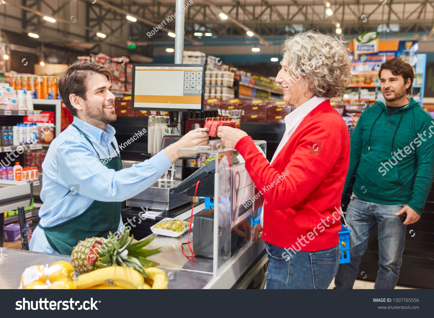 customer-pays-by-cashier-customer-card-1507765556-shutterstock