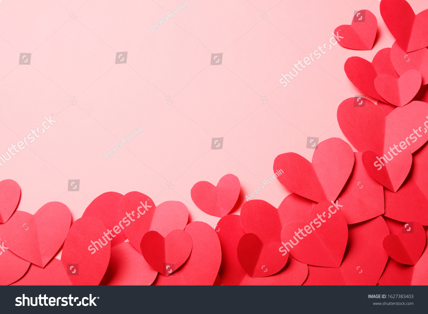 Cut out of red paper hearts on pink background. Good Valentines day, Womans day, love, romantic or wedding composition with copy space for your text for banner, congratulation, card, offer, flyer, advertising, invitation.