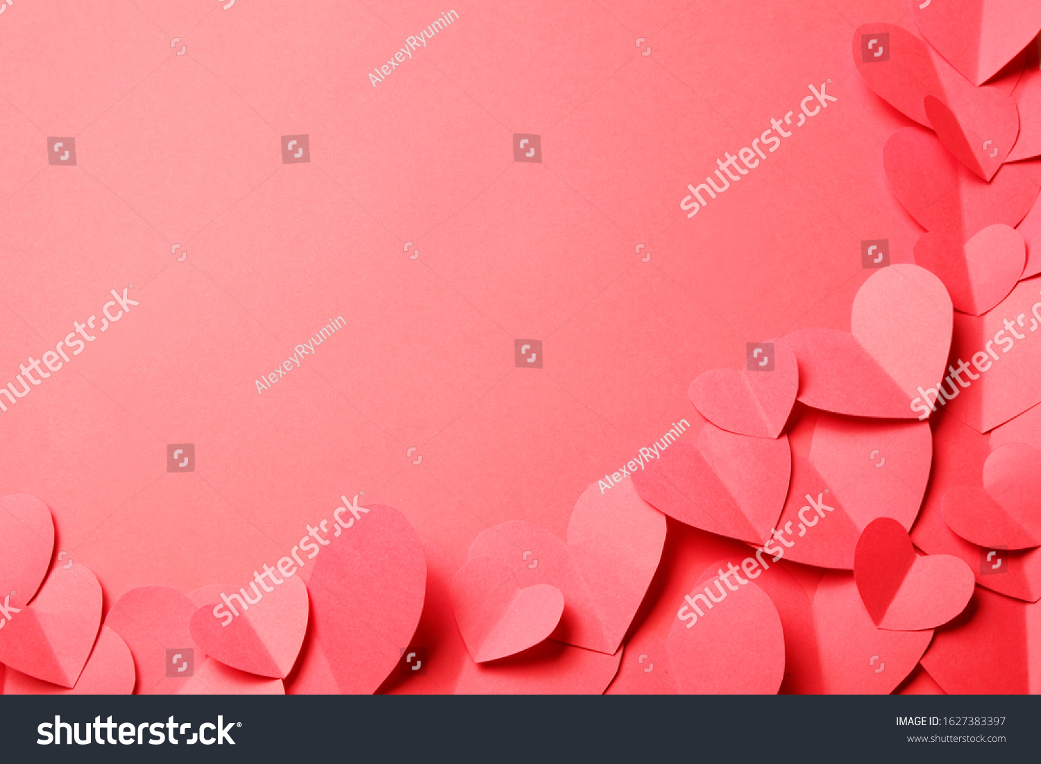 Cut out of red paper hearts on red background. Good Valentines day, Womans day, love, romantic or wedding composition with copy space for your text for banner, congratulation, card, offer, flyer, advertising, invitation.