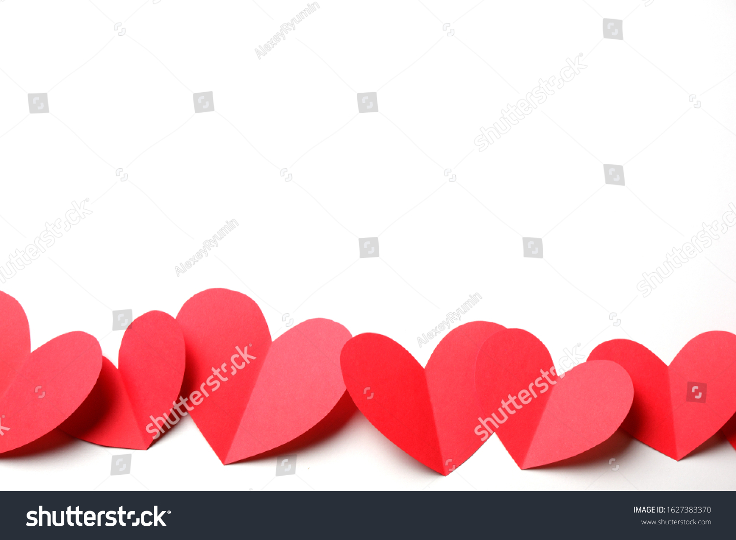 Cut out of red paper hearts on white background isolated. Cute Valentines day, Womans day, love, romantic or wedding composition with free space for your text for banner, congratulation, card, offer, flyer, advertising, invitation.