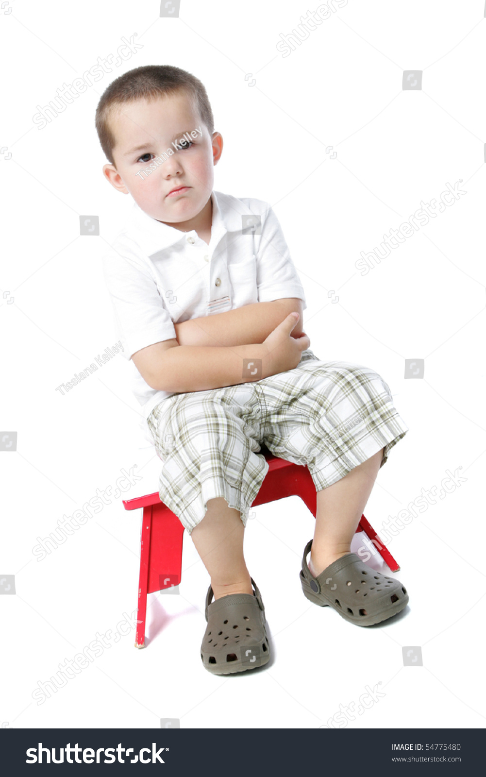 Cute Little Boy Sitting On A Red Stool And Pouting Stock Photo 54775480 ...