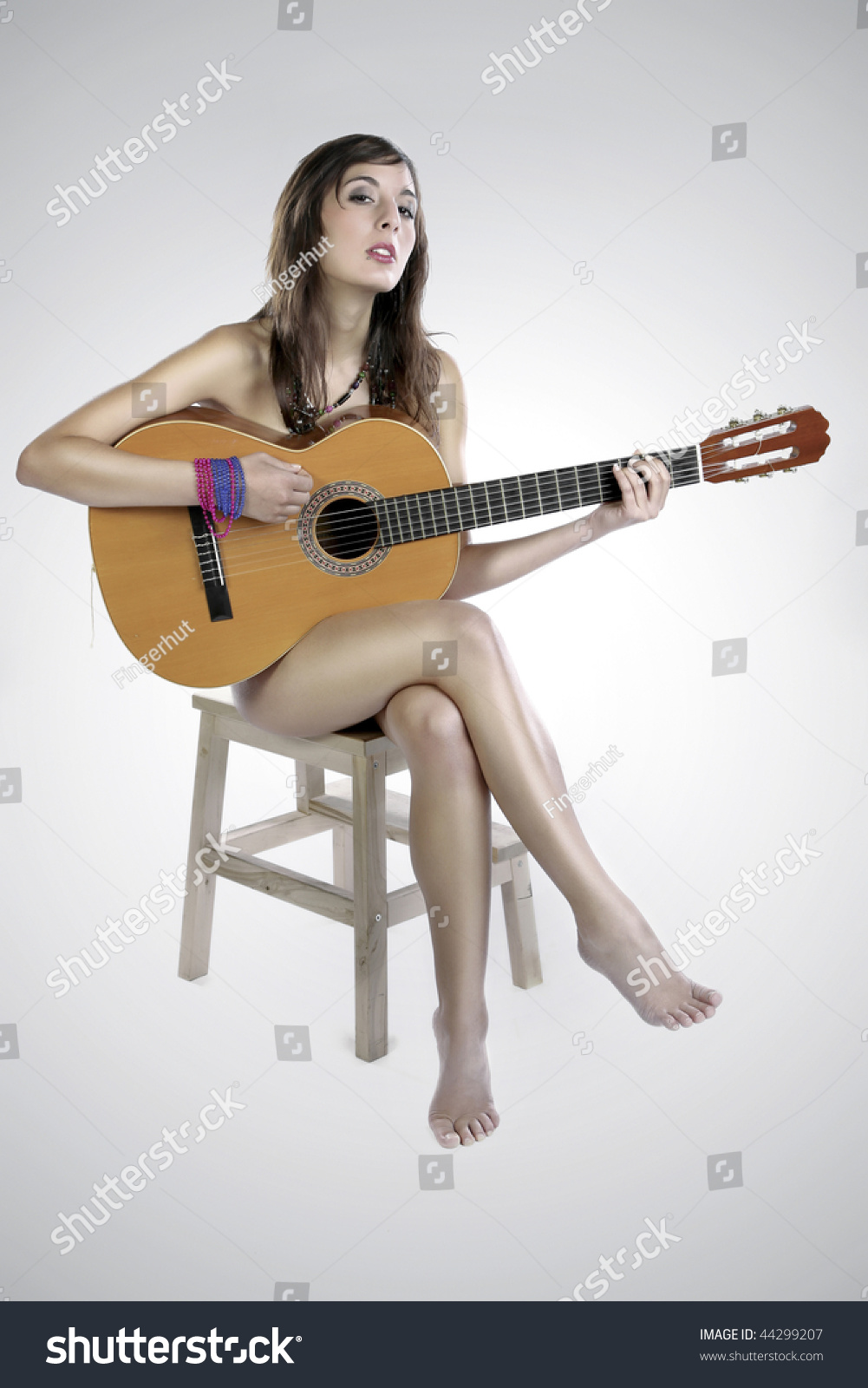 girl playing guitar topless