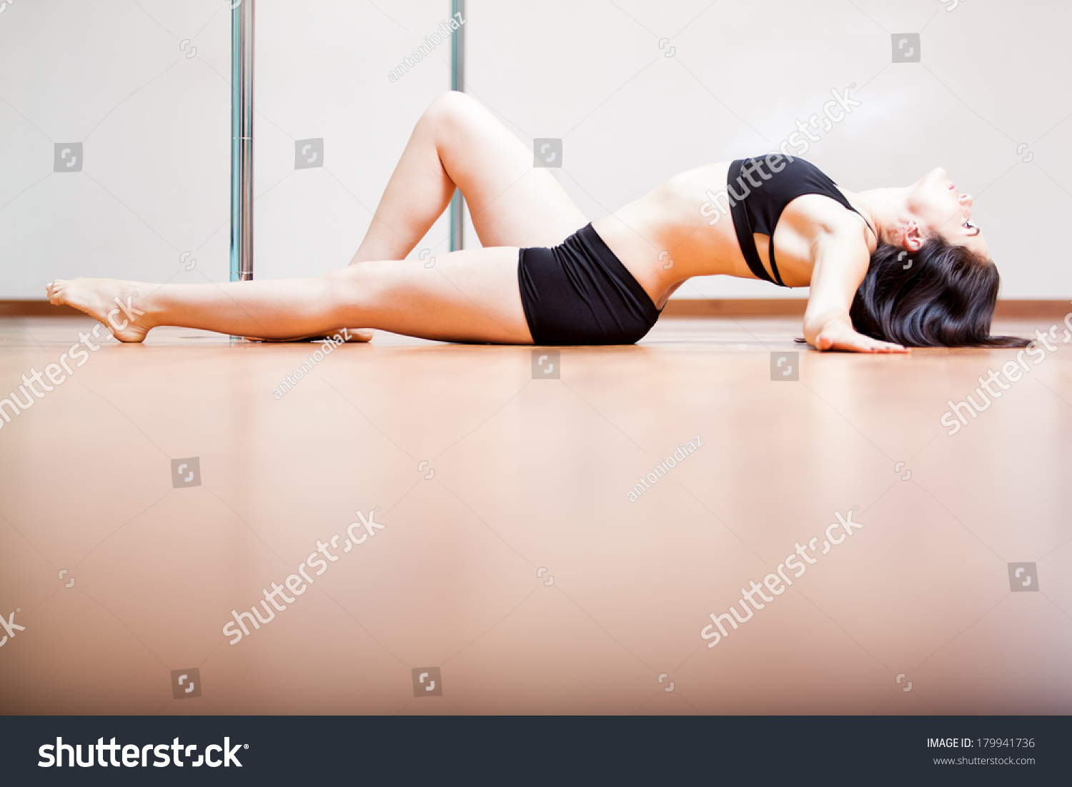 Young brunette laying on the floor wrapped in red tape