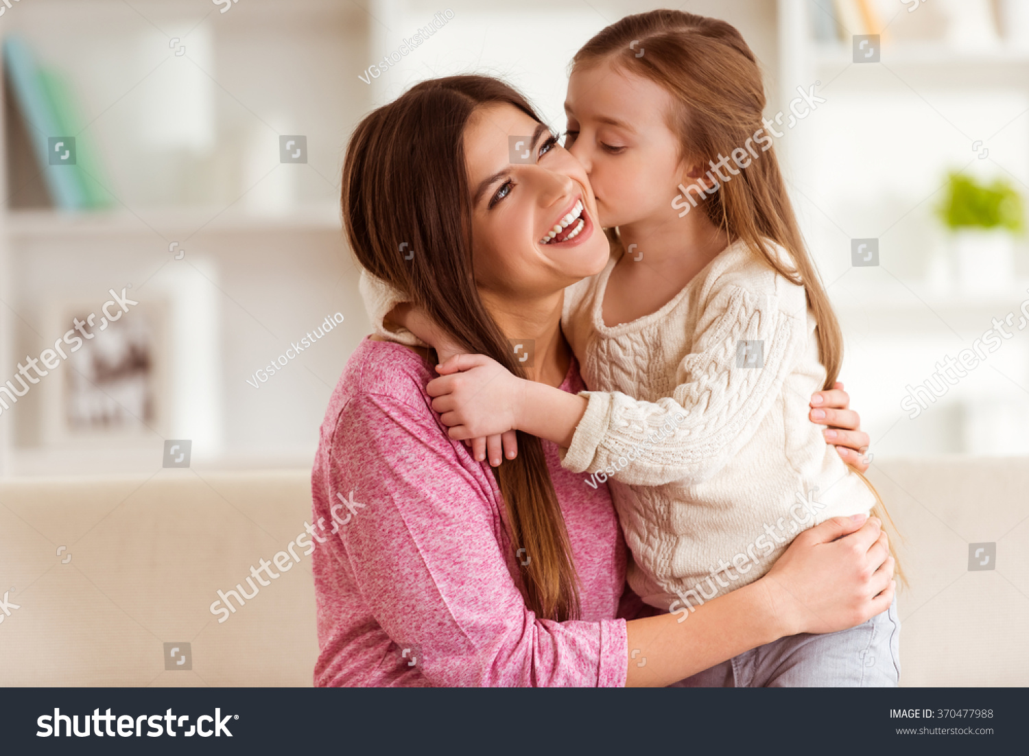 Daughter Kissing Her Happy Mother EmbracesẢnh Có Sẵn370477988