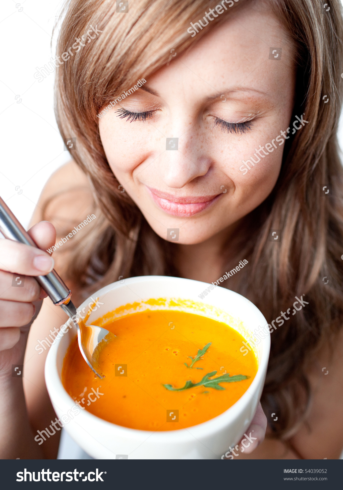 Delighted Woman Holding A Soup Bowl Against A White Background Stock ...