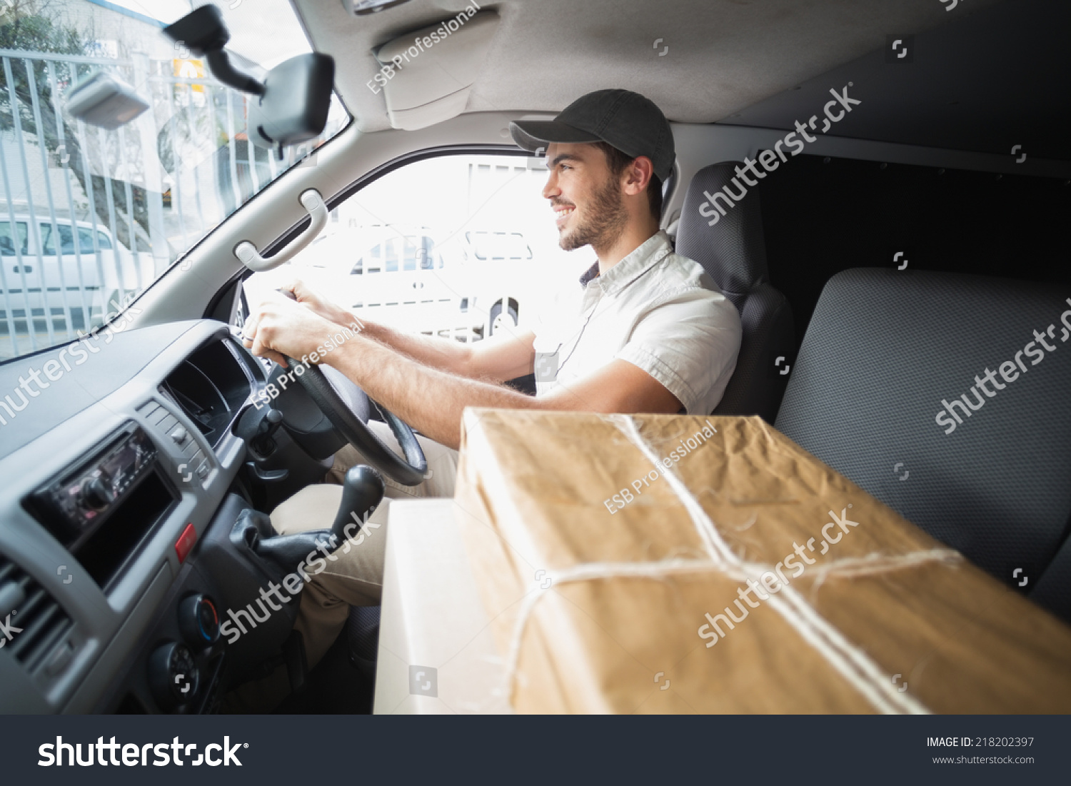 delivery-driver-driving-van-parcels-on-stock-photo-edit-now-218202397